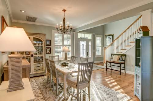 First-time buyers talking with an agent outside a home